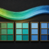 Where Does Blue End and Green Begin? Conceptual illustration of a continuous green-to-turquoise-to-blue color band above rows of painted color chips, grouped differently by thin brass dividers against a charcoal background; the differing groups represent language-specific color categories, not measured experimental data.