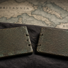 What Did a Roman Soldier’s Bronze Diploma Actually Buy? Illustrative reconstruction of two patinated Roman bronze diploma tablets with engraved rows and wire bindings, lying on dark cloth before a stylized map marked Britannia and Roma; not a reproduction of Reburrus’s actual diploma.