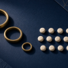 How Can Remainders Put a Number Back Together? Three brass rings of descending sizes and fourteen ivory-colored counting stones on dark blue paper, an illustrative still life evoking the separate cycles used in the Chinese remainder theorem rather than a literal diagram of its 3, 5, and 7 moduli.
