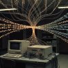 How Did the Internet Stop Choking on Its Own Traffic? Late-1980s computer terminal and network equipment as packets of light bunch at a bottleneck, then flow in measured order.